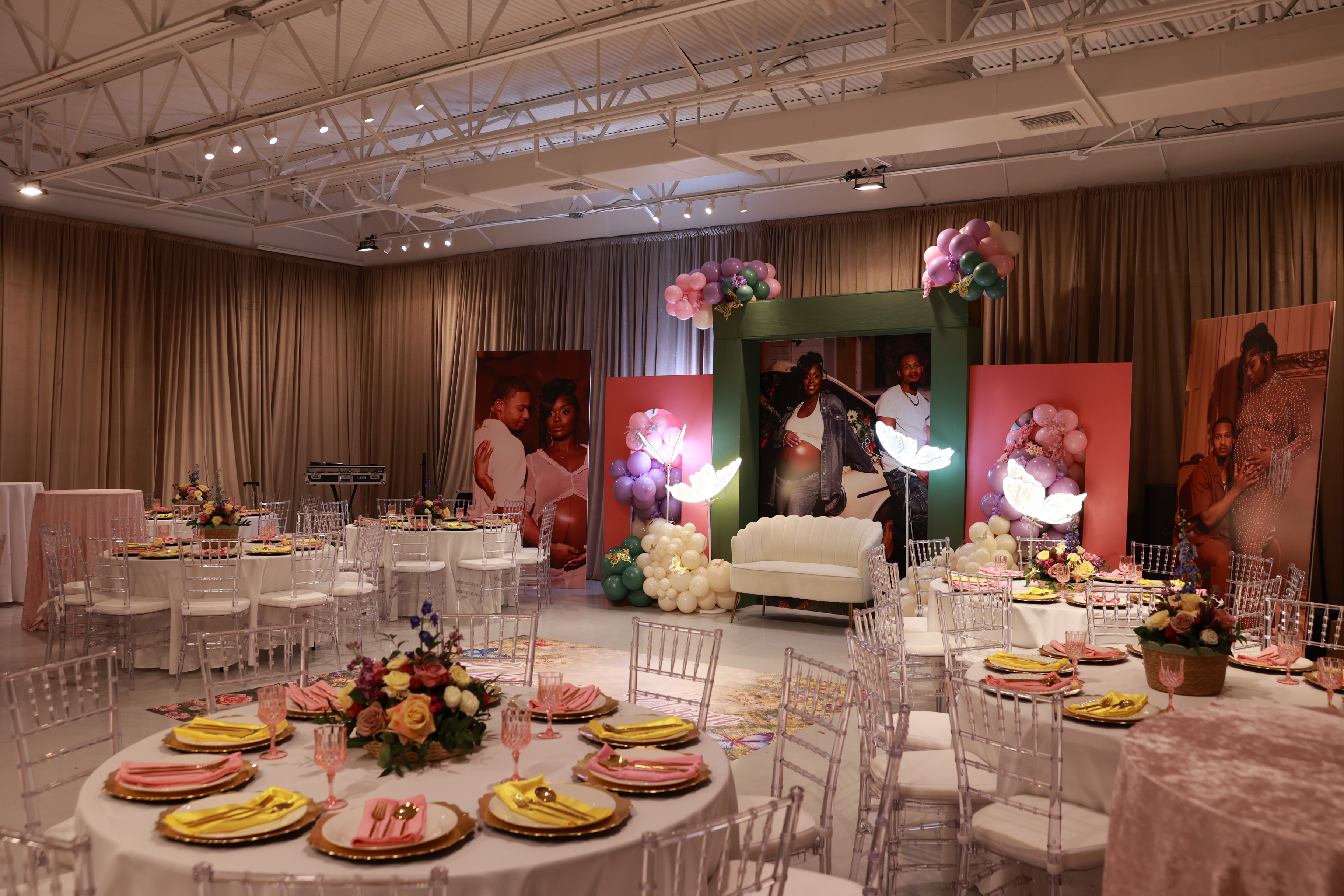 Garden-themed baby shower decor with colorful balloons and custom signage